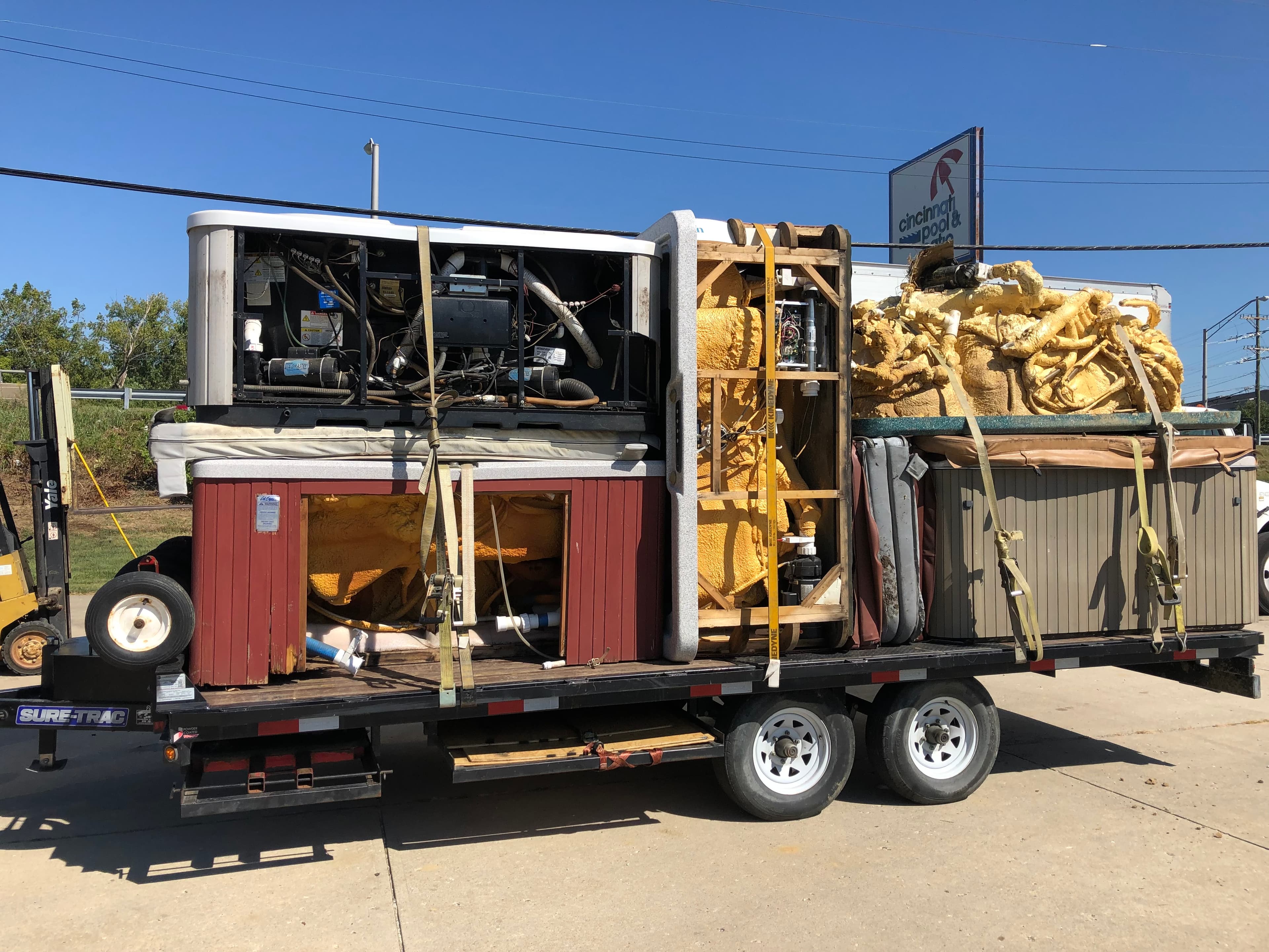 Flatbed trailer loaded with removed hot tub units